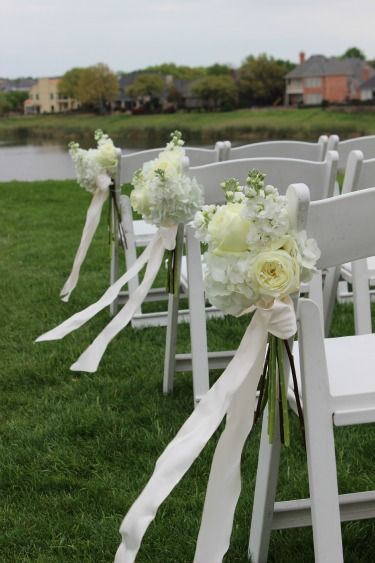 Wedding Wednesday: Tiffany’s Wedding White Resin Chairs Wedding, Resin Chairs Wedding, Unity Candle Arrangement, Church Aisle Decorations, Wedding Church Aisle, Pew Flowers, Chairs Wedding, Wedding Wednesday, Altar Flowers