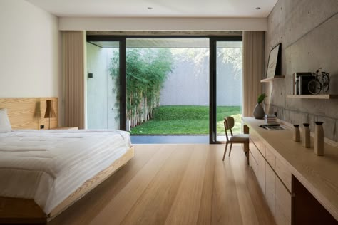 Gallery of Hikari House / PranalaAssociates - 11 3 X 4 Bedroom Ideas, Bedroom With Garden View, Glass House Interior, Bedroom With Patio, Pranala Associates, Bedroom With Garden, Ground Floor Bedroom, Bedroom View, Modern Tropical House