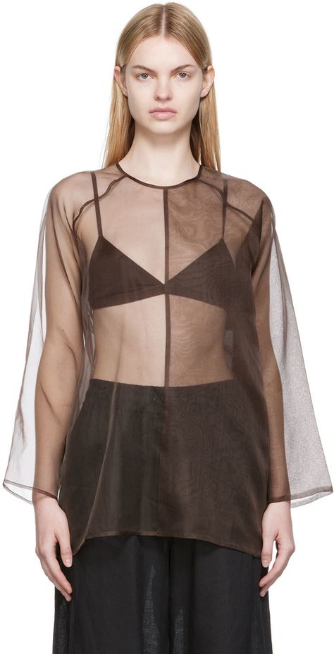 Sheer silk organza blouse. · Paneled construction · Crewneck · Single-button closure and cut-out at back Supplier color: Taupe Sheer Organza Top, Sheer Button Up, Medieval Blouse, Organza Tops, Dolman Shirt, Khaki Tops, Organza Blouse, Organza Top, Black Sheer Top