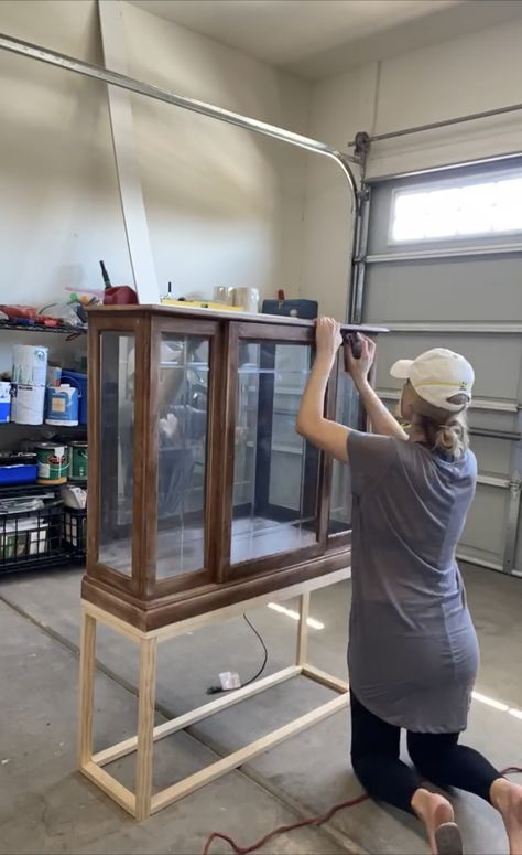 This upcycled DIY curio cabinet is a high-end dupe, but cost just $112 | Real Homes Curio Cabinet Jewelry Display, Add Legs To China Cabinet, Diy Glass Display Cabinet, Antique Cabinet Styling, Refurbished Glass Cabinet, Display Case Makeover, Diy Glass Display Case, Curio Cabinet Makeover Modern, Repurpose Curio Cabinet