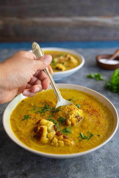 Roasted cauliflower soup is creamy, and rich without any cream! Made with just a few ingredients, this cauliflower soup is vegetarian, dairy free and gluten free. Read on to learn how to make this easy soup at home with only a few ingredients in less than one hour. Vegetable Tikka Masala, Easy Cauliflower Soup, Cauliflower Soup Recipe, Persian Recipes, Creamy Cauliflower Soup, Roasted Cauliflower Soup, Cauliflower Soup Recipes, Easy Cauliflower, Roasted Butternut Squash Soup