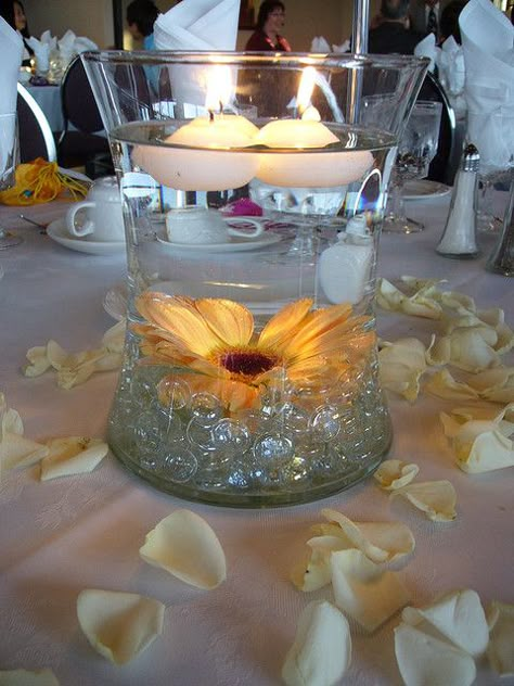 Centerpiece idea: Marbles on the bottom with a sunflower and floating candles on top. Perfect for the money conscious bride who loves some "color pop" on her table! Our  www.specialeventsinstitute.com wedding course students might use this idea in an inspiration board! Purple Floating Candles, Purple Centerpieces, Candles Vintage, Sunflower Centerpieces, Floating Candle Centerpieces, Gerber Daisy, Floating Candle, Centerpiece Wedding, Polka Dot Wedding