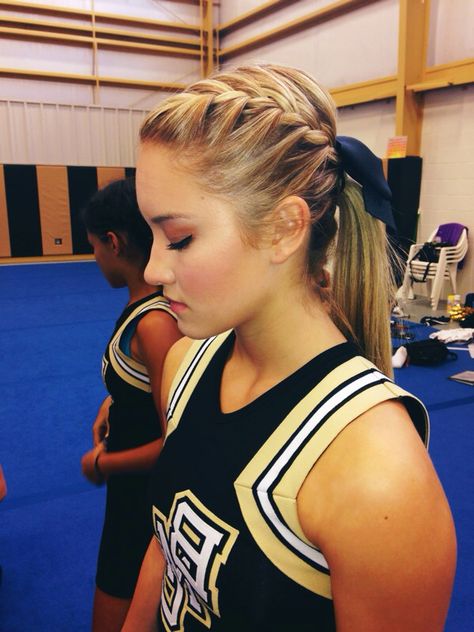 cheer hair Cheer Hair Braids, Dutch Braid Cheer Hair, Ponytail Hairstyles For Cheer, Low Cheer Ponytail With Bow, Low Pony Hairstyles For Cheer, Football Cheer Hairstyles, Low Ponytail Cheer Hair, Cheer Leading Hairstyles, High School Cheer Hairstyles