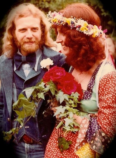 Beautiful vintage photo from a 1970s wedding of the bride and groom, vintage 1970s hippie wedding - the bride has a pretty flower crown on her head and a bouquet of roses with trailing ivy and a patchwork hippie dress, the groom is wearing a rockin' ass denim vest and suit jacket and equally rockin' sideburns and beard and long wavy hair 1970s Wedding, Boho Style Wedding Dress, Fairytale Gown, Wedding Dresses Hippie, Berkeley California, Iconic Weddings, Vintage Brides, Hippie Wedding, Bridal Musings