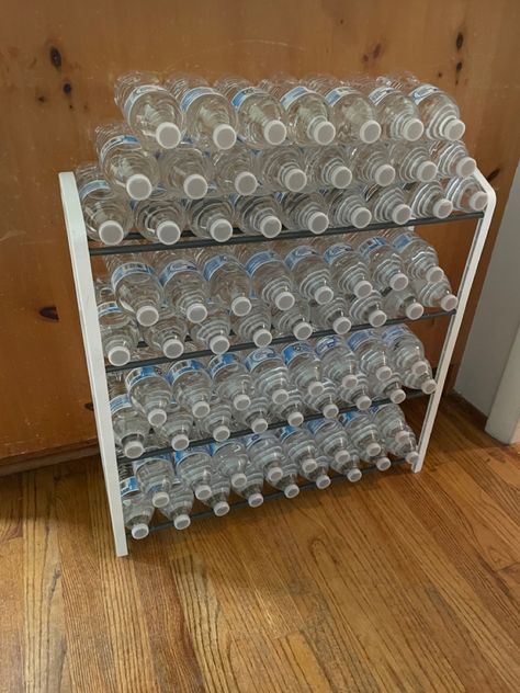 No more water cases sitting in the floor! $8 shoe rack from Walmart. Holds 2 cases of water! Shoe Rack For Water Bottles, Shoe Rack Drink Storage, Water Storage Ideas Home, Bottled Water Storage Ideas, Pop Organization, Drink Organization, Diy Dollar Store Organization Ideas, Soda Storage, Dollar Store Organization Ideas