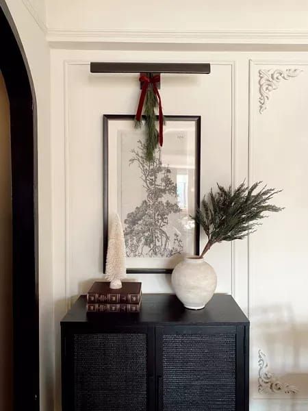 Art light (battery operated), small cabinet, vase with branches, Christmas decor for the home, Christmas, Christmas aesthetic, art art prints, home, entryway ideas, entryway decor | @prettyinthepines, New York City Lifestyle Blog #Christmas #decor #home Entryway Console Christmas Decor, Modern Classic Christmas Decor, Small Cabinet Decor, Christmas Decor Ideas For Living Room, Christmas Decor Entryway, Hallway Nook, Christmas Entryway Decor, Minimal Christmas Decor, Holiday Entryway Decor