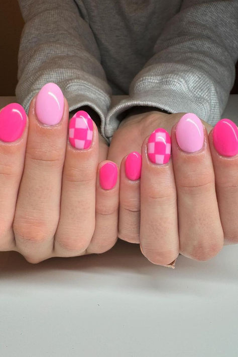 Fun and Flirty: Vibrant Pink Oval Nails with a Checkered Accent Nail Design - A playful mix of bold pinks and soft pastels, enhanced with a charming geometric pattern, perfect for a pop of color and subtle twist! // Photo Credit: Instagram @nailsbylexih Cute Short Oval Acrylic Nails, Nail Ideas Checkerboard, Purple Nails Checkered, Round Nail Ideas Summer, Short Nail Cute Designs, Checkered Accent Nails, Neon Pink Acrylic Nails Designs, Cute Fun Summer Nails, Western Fall Nail Ideas