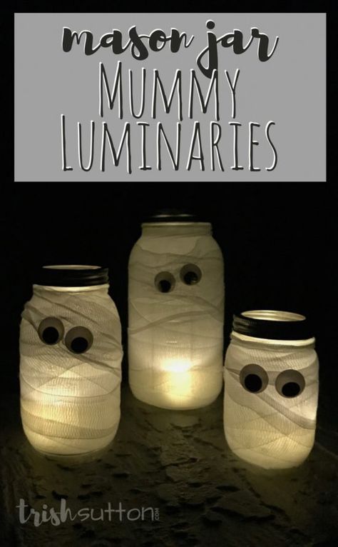 Mason Jar Mummy Luminaries are a simple and silly way to add Halloween cheer both outdoors and indoors. Along with the Mason Jars you will need a roll or two of first aid gauze and tea lights or candles. (Add my favorite battery operated tea lights and you won't even have to remember to light your mummies at night - they have timers!) TrishSutton.com Thanksgiving Yard Decorations, Mummy Jar, Halloween Luminaries, Mason Jar Luminaries, Spooky Halloween Decor, Stag And Doe, Halloween Mason Jars, Battery Operated Tea Lights, Halloween Centerpiece