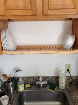 Opt for a Smart Drying RackWe know, your plates have to dry somewhere. But whoever thinks they need to take up a chunk of valuable counter space to do so is missing out. This nifty rack fits into a nook between cabinets and keeps wet plates out of the way.Get the tutorial at Instructables » Kitchen Sink Drying Rack, Sink Drying Rack, Kabinet Dapur, Trendy Apartment, Space Apartments, Over The Sink, Kitchen Cabinets Makeover, Dish Rack, Apartment Bathroom