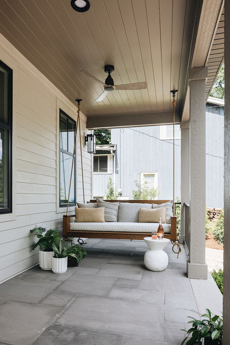 This lake house front porch is completed with a wood plank ceiling, ceiling fan and quintessential porch swing.   Design by Two Hands Interiors. View more of this lake house on our website.  #lakehouse #porch Lake House Front Porch, Lake House Porch, Wood Plank Ceiling, House Porch, House Front Porch, Plank Ceiling, Swing Design, House With Porch, Virtual Design