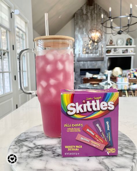 A tall glass tumbler full of pink drink with a skittles wild berry variety pack of water flavor packets beside it Skittles Water Flavor Recipes, Beautiful Drinks, Skittles Drink, Homemade Snow Cones, Passion Tea Lemonade, Clear Glass Tumbler, Passion Tea, Low Calorie Drinks, Flavored Water Recipes