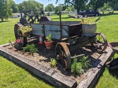 Wagon Landscaping Ideas, Farm Machinery Yard Art, Old Hay Rake Yard Decor, Antique Farm Equipment Landscape, Old Farm Equipment Landscaping, Farm Equipment Landscaping, Iron Wheel Ideas Yards, Farmyard Landscaping, Farm Equipment Decor