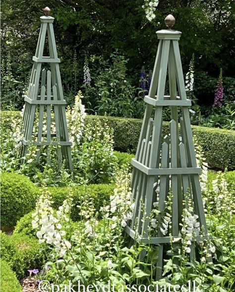 French Garden Obelisk, Flower Bed With Trellis, White Garden Obelisk, Climbing Rose Obelisk, Garden Obelisk Ideas Focal Points, Wooden Garden Obelisk, Garden Oblesik, Diy Garden Obelisk Trellis, Obelisk Trellis Diy How To Build