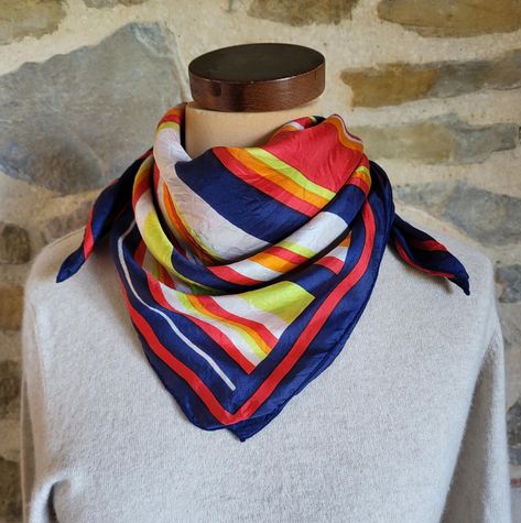 A vintage silk scarf with a striking square pattern of multicolor stripes in red, white, orange, lime green and white on a navy blue background. "Soie" (silk) label Measurements: 26 x 26 inches (66 x 66 cm) In good vintage condition.  There can be considerable savings made on combined shipping. If you are purchasing multiple items please contact me for an accurate price. The shipping includes tracking, if you want to add insurance and a signature on delivery please purchase the shipping upgrade. I have many items of vintage accessories including scarves, belts and gloves in my shop FinishingTouchFemme, please pop in to take a look! https://www.etsy.com/shop/FinishingTouchFemme