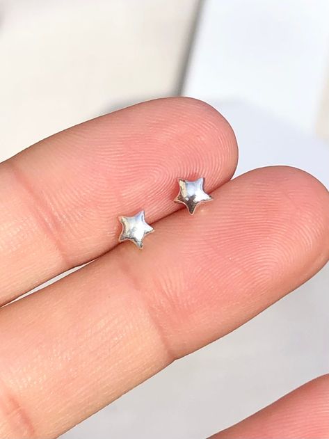 1 x pair of Tiny solid star stud earrings These delicate stud earrings are handmade of 925 sterling silver with a star design, bright and shine little cute one. Dimensions (approx): * 5x5 mm ✔ Nickel, Lead free & Hypoallergenic ✔ Perfect for sensitive skin ✔ Every order comes with a Beautiful gift box, ready for gifting WORLDWIDE SHIPPING All orders will ship within 1-2 working days once payment received * 3-5 working day for Australia wide * 10 -14 working days to USA * 14-20 working days REST Simple Silver Stud Earrings, Silver Star Stud Earrings, Silver Star Earrings Studs, Silver Earrings Design, Tiny Silver Earrings, Silver Earrings Stud, Aesthetic Stud Earrings, Fun Stud Earrings, Star Earrings Aesthetic