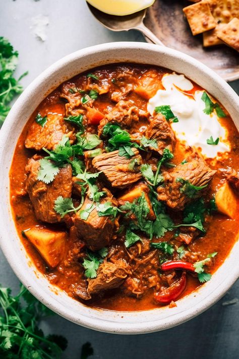 "Indulge in this Indian-style lamb curry, my delicious take on Rogan Josh with tender lamb in a rich, tomato sauce, spiced just right. It's the perfect comfort food, flavourful but not too spicy, with options to add more spice if you like. This easy curry only takes 20 minutes to prep and can be made either in a slow cooker or on the stovetop. It's a must-try for a cozy, satisfying meal. While this curry is not a traditional rogan josh, in that I use coconut milk and soy sauce for a Indian Lamb Curry, Lamb Curry Recipes, Slow Cooker Curry, Homemade Naan Bread, Pork Curry, Rogan Josh, Easy Curry, Lamb Curry, Slow Cooked Lamb