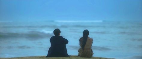 Couple from kdrama 'Doona' sitting on beach near each Baesuzy Aesthetic, Amnesia Trope, Couple Sitting On Beach, Beach Cinematography, 18th Photoshoot, Beach Movies, Cinematography Ideas, Sitting On Beach, Blue Couple