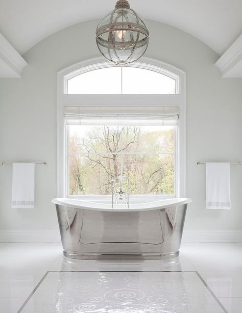 Restoration Hardware Victorian Hotel Pendant illuminates a master bathroom above a silver modern cast iron bathtub designed at a picture window fitted with a white Roman shade. Melanie Turner Interiors, Niche Decor, Silver Bath, Mermaid Bathroom Decor, Kids Bathroom Wall Art, Refinish Bathtub, Cast Iron Bathtub, Jetted Bath Tubs, White Tile Floor