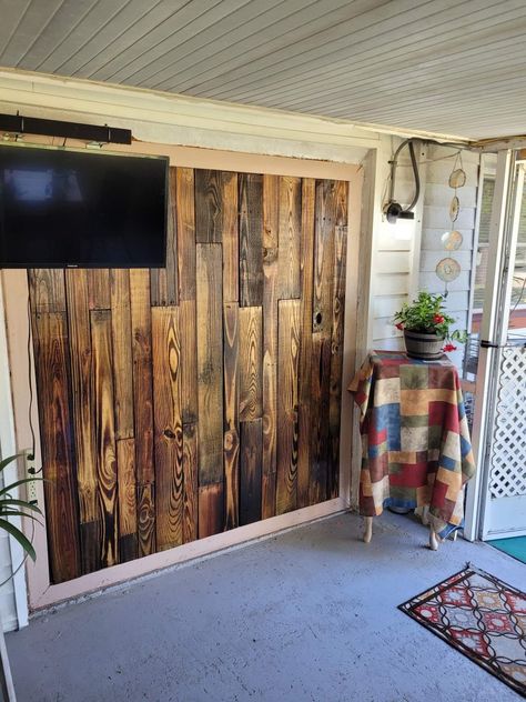 The wood was sanded, burned with a blow torch, & polyurethaned. 
A nice back drop for our porch. Pallet Walls, Wood Pallet Wall, Camper Renovation, Pallet Wall, Pallet Wood, Wood Pallets, Wood Wall, Room Divider, Wood