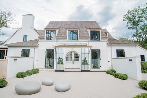 Home exterior features white stucco, cedar wood trim, custom black window frames and handmade front door from Poland. Belgian Farmhouse, Classical Villa, French Country Exterior, Stucco Siding, Black Window Frames, European Style Homes, Belgian Style, Casa Exterior, House Building