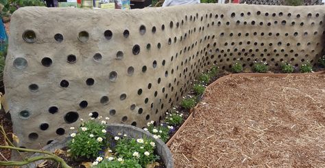 Cob wall with decorative bottles/ Permaculture/ Natural building/ San Diego County Fair exhibit Cob Fence, Wine Bottle Fence, Bottle Fence, Cob Wall, Sand Clay, Straw Bale House, Temple Gardens, Decorative Bottles, Cob House