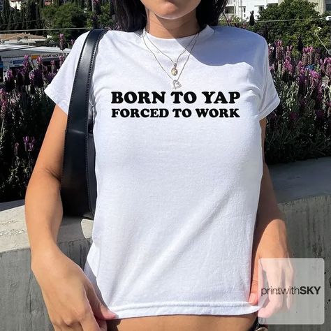 📣 Calling all chatterboxes and style mavens! 🌟 Introducing the cheeky and chic "Born to Yap Forced to Work Baby Tee" by printwithsky! This isn't just any tee; it's a statement of your playful spirit wrapped in the comfort of 100% cotton. 🌿 #Y2KAesthetic #GirlPower #babytee #printwithsky #streetwear #trendytop #GraphicTee #BabyTee #pinterestinspired #londonfashion #londonstyle #lafashion #lastyle #nycstyle #nycfashion #springinspo #summeroutfit #summerinspo #90s #90sfashion #ootdfashion #dis... Funny Baby Tees, 90s Baby, Trendy Top, Baby T Shirts, Fitted Tee, Funny Baby, Limassol, Y2k 90s, Trendy Tops