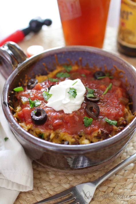 You won't believe how easy it is to make this Taco Casserole! Add seasoned ground beef and cheese between crisp layers of crunchy tostadas and bake in the oven. A quick, easy, and tasty single serving meal.| One Dish Kitchen Casserole For One, Southwestern Dishes, Single Meals, Ramekin Recipes, Hotel Meals, Easy Taco Casserole, Meals For 1, Batch Baking, Food For Two