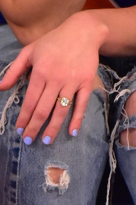 Miley Cyrus Showed Off a Massive New Engagement Ring From Liam Hemsworth | Teen Vogue Miley Cyrus Engagement Ring, Miley Cyrus Show, Knicks Game, Paper Rings, Ny Knicks, White Bridal Bouquet, Paper Ring, Liam Hemsworth, Teen Vogue