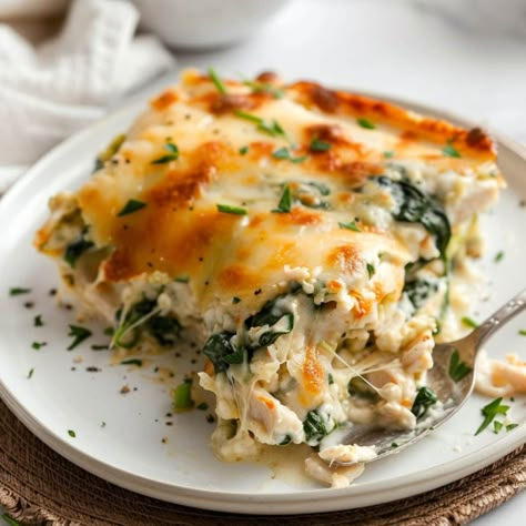 This chicken and spinach casserole with cream cheese is creamy and dreamy. And the golden, bubbly cheese on top makes everything better. Spinach And Cheese Ravioli With Chicken, Chicken Veggie Lasagna Recipe, Creamy Chicken And Spinach Casserole, Baked Spinach Casserole, Chicken Cream Cheese Spinach, Large Meals For A Crowd, Italian Casserole Recipes, Chicken Spinach Casserole, Cream Cheese Recipes Dinner