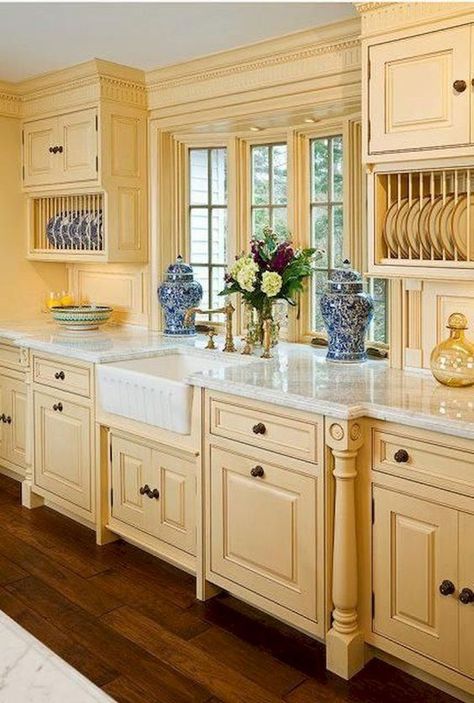 Cabinetry via   Superior Woodcraft Inc.   in a traditional kitchen. The cabinetry, walls, and millwork are all painted the same buttery shade. #yellow #colortrends #colorpalette #colorideas #interiordecor #interiordecorideas #interiordesignideas #interiordesign #yellowcolorpalette #yellowcolorscheme Modern French Country Kitchen, French Country Kitchen Cabinets, French Country Kitchen Designs, French Country Decorating Kitchen, Yellow Cabinets, Country Kitchen Cabinets, Long Kitchen, Country Kitchen Designs, French Country Kitchens