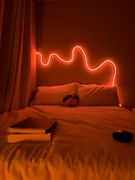 View of bed in bedroom with neon led rope light on orange Rope Lights Bedroom Ideas, Bedroom Rope Lighting Ideas, Rope Light Bedroom, Led Rope Lights Bedroom, Led Rope Lighting Ideas, Rope Light Design, Rope Lights Bedroom, Bed Snap, Lights Above Bed