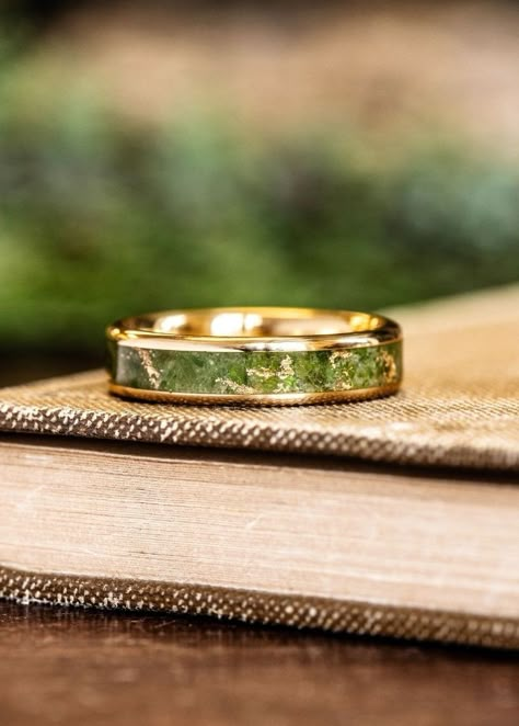 custom 18k yellow gold ring green imperial diopside gold flakes inlay laying on book rustic and main Non Traditional Wedding Bands Men, Mens Alternative Wedding Band, Peridot Wedding Band Men, Peridot Ring Men, Peridot Ring For Men, Unique Engagement Rings Men, Unique Rings For Men, Ring Designs For Men, Gemstone Rings For Men