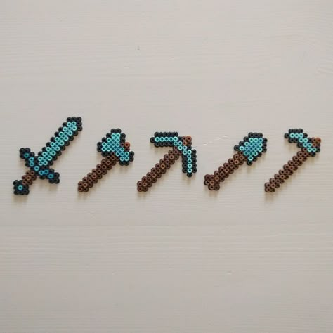 Diamond sword and tools from the game Minecraft. Made with Artkal C mini fuse beads. Read more about it on my DeviantArt page deviantart.com/ThisThatWithCat Minecraft Tools, Diamond Armor, Minecraft Beads, Minecraft Diamond, Mini Hama Beads, Birthday Shirt Ideas, Hamma Beads Ideas, Easy Perler Bead Patterns, Pixel Beads