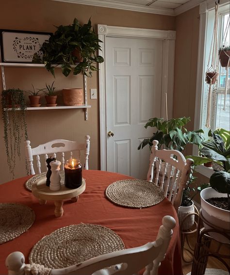 Accent wall in dining room plant wall metal shelving for plants plant mama watm cozy house plants terra cotta planters cozy dining room boho dining room tablecloth warm tones Shelving For Plants, Accent Wall In Dining Room, Dining Room Boho, Terra Cotta Planters, Warm Dining Room, Cozy Dining Room, Dining Room Tablecloth, Earthy Living Room, Boho Dining Room