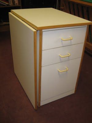 drop leaf table design. Attach the top to the wall, hinged either up or down, and use a leg similar to this, attached to the wall, that folds up against the wall when not in use. Could either do it square like this, or a triangle so it doesn't rest on the floor. Drop Leaf Craft Table, Storage With Folding Table, Cabinet With Folding Table, Hinged Table On Wall Diy, Drop Leaf Table Hinge, Woodworking Projects Unique, Fold Down Table, Drop Down Table, Ikea Crafts