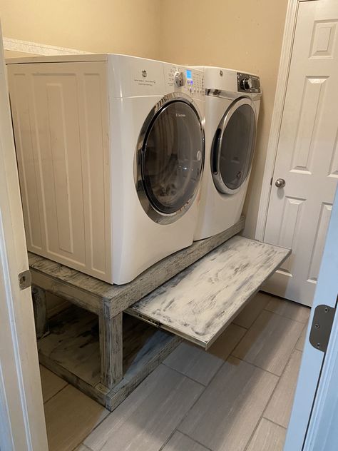 Elevated the washer and dryer so that I don’t have to break my back bending over... added pull out table to set basket onto... Washer Dryer Platform Ideas, Washer And Dryer Base, Laundry Room Design Pedestal, Shoe Storage Under Washer And Dryer, Stands For Washer And Dryer, Washer And Dryer Riser, Washing Machine Pedestal Platform, Washer And Dryer Enclosure, Wooden Washer And Dryer Pedestal