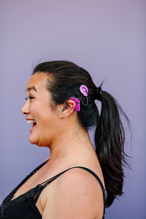 Happy woman with pink cochlear implant by Erin Brant for Stocksy United #stocksy Cochlear Implant Aesthetic, Leadership Photoshoot, Hair In Ponytail, Portrait Faces, Cochlear Implants, Cochlear Implant, Purple Wall, Branding Inspo, Happy Woman