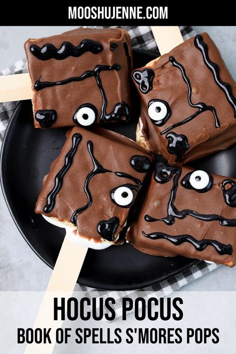 Hocus Pocus Book Of Spells S'mores Pops on a black plate with gray plaid napkin on a concrete back drop. Hocus Pocus Book Of Spells, Spooky Desserts, Smores Pops, Hocus Pocus Book, Cold Snack, Halloween Spell Book, Hocus Pocus Spell Book, Hocus Pocus 2, Halloween Food Desserts