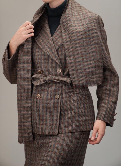 This exquisite Italian tailor-made ensemble from the 1980s is a celebration of fine craftsmanship and timeless style. The set includes a double-breasted jacket, pencil skirt, and a generously sized scarf, all crafted from a luxurious wool blend in a subtle brown and rust plaid pattern. Designed to exude elegance, the pieces can be worn together for a sophisticated look or separately for endless styling versatility. The double-breasted jacket features a belted waist and impeccable tailoring, creating a flattering silhouette. The matching pencil skirt has a classic high waist and falls below the knee, making it a perfect choice for both workwear and formal occasions. The wool scarf adds a touch of refinement and warmth, with its oversized dimensions making it easy to style in various ways. I