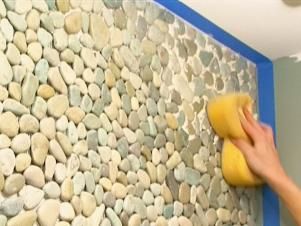 Create a dramatic focal point in a once boring bathroom by covering an entire vanity wall with pebble tile. Learn how on DIYNetwork.com. Rock Bathroom, Beadboard Backsplash, Pebble Tile, Herringbone Backsplash, Diy Backsplash, Bathroom Redo, Trendy Kitchen, Bergamo, Diy Backyard