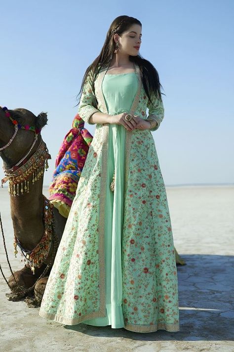 Leave a mark with this demure sea green colored designer anarkali suit falling plain all over with a front open jacket featuring string tie-ups and kundan border layering the suit for glam. Jacket is done up all over in lovely resham & zari floral patterns in a blissful feel! This suit is accompanied by matching leggings. डिजाइनर कपड़े, Long Gown Dress, Long Dress Design, Salwar Kamiz, Indian Gowns Dresses, Kurti Designs Party Wear, Indian Gowns, Party Kleidung, Stylish Party Dresses