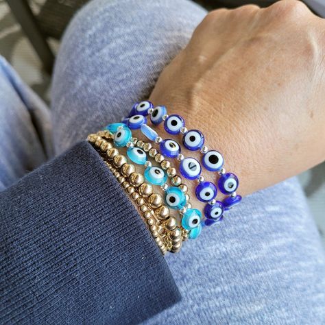 Wear a bead bracelet in evil eyes for women everyday to change your luck and fortune. Add in a collection of bracelets, or just wear a single one. Eye Bead Bracelet, Light Blue Eyes, Hamsa Earrings, Eye Bracelets, Eye Decor, Diamond Evil Eye, Red String Bracelet, Lucky Bracelet, Evil Eyes