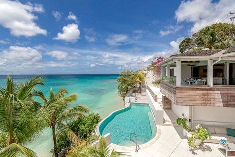 New! Portobello, St. James, Barbados. Named after one of the most stylish roads in West London is Portobello Villa, the latest luxury holiday rental villa on the West Coast of Barbados. This beachfront pad includes 5 ensuite bedrooms, all of which offer mesmerizing sea views and privacy whilst communal areas bring cherished guests together on the sea-facing terrace with luxury sun loungers, one-of-a-kind infinity-edge pool or the multiple dining and lounging areas. The 5th bedroom doubles up as Edge Pool, Sun Loungers, Infinity Edge Pool, Pool Villa, Luxury Holiday, Luxury Pool, Luxury Rentals, Wealth Creation, Villa Rental