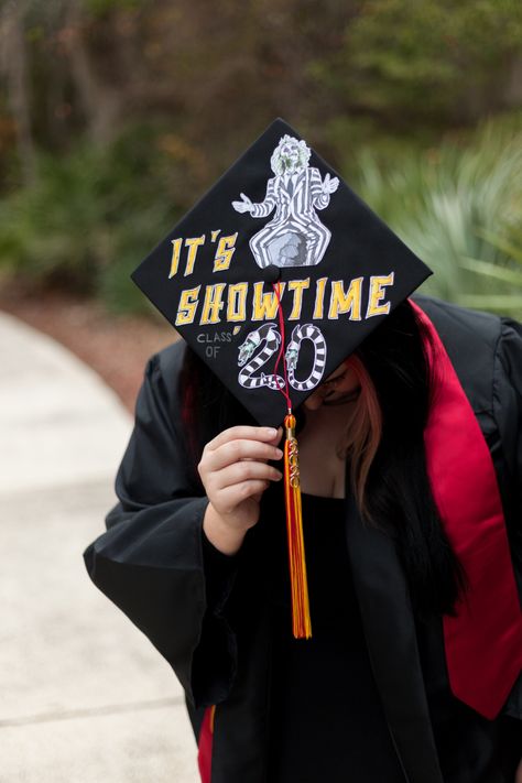 I designed my grad cap around one of my all time favorite movies, Beetlejuice, with his most fitting catchphrase for the occasion- “Its Showtime”! I wanted to incorporate some sandworms, so I drew them as my graduating class year Wednesday Addams Graduation Cap, Nightmare Before Christmas Graduation Cap, Beetlejuice Graduation Cap, Graduation Cap Designs Nightmare Before Christmas, Heathers Graduation Cap, Nightmare Before Christmas Grad Cap, Spooky Graduation Cap, Graduation Cap Designs Tim Burton, Tim Burton Graduation Cap