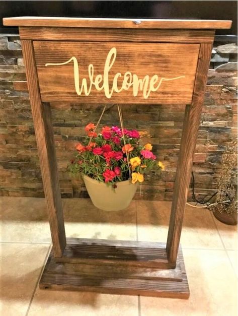 I have seen many planters like this, and I wanted to try making one myself. This is a great addition for your summer porch! Here's how I made it.Here is my cut list:2x4” 2@ 36” sides2x4 2@ 22” top and bottom frame2x10” 1@ 26” very bottom1x8 2@ 24” bottom and finishing top1x8” 19.5” cut lastFirst cut all of the boards you'll need. Once cut, sand all of them down.Next, lightly dry brush some white paint on all sides of the boards.Next, paint some wood stain over the paint- this will… Plant Stand Plans, Welcome Stand, Hanging Basket Stand, Planter Hanger, Woodworking Gifts, Garden Spheres, Diy Concrete Planters, Wood Planter Box, Wood Planter