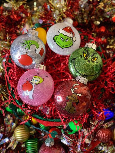 Tis the Season to Deck your Tree with these Custom Grinch Inspired 5 Piece Ornaments These are 3 x 3.5 ornaments. Comes with 5 Custom Ornaments, The Grinch Face, The Grinch hand, Max, Cindy Lou Who, Santa Grinch Accent your tree with just the right amount of this classic favorite! Get into the The Grinch Hand, The Grinch Face, Nightmare Before Christmas Ornaments, Grinch Hand, Grinch Decorations, Grinch Trees, Grinch Christmas Party, Whoville Christmas, Grinch Christmas Tree