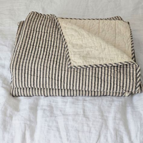 Whether you're creating a farmhouse style bedroom, a cozy cabin nook or a cottage guest room, our Charcoal Ticking Stripe Quilt offers vintage charm. This hand-quilted, 100% cotton coverlet gets softer with each washing. Features popular ticking stripes in charcoal along with a buttery oat stripe on one side and a solid buttery oat on the reverse side. Twin is 68" x 86" and includes one matching 21" x 27" pillow sham Queen is 90" x 90" California King is 130" x 115" King is 105" x 95" and includ Traditional Cozy Bedroom, Farmhouse Cabin Bedroom, Vintage Little Boys Room, Gingham Bedroom, Blanket Styling, Cottage Guest Room, Neutral Quilts, Cottage Bedding, Farmhouse Style Bedroom