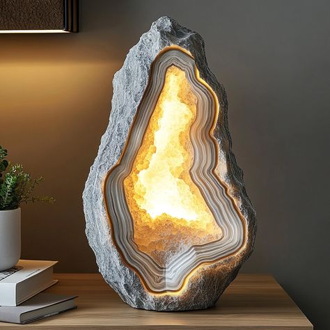 The Geode Lamp is a stunning fusion of nature and light, inspired by the raw beauty of geodes. This unique lamp features a crystal-like structure with a textured, mineral exterior and a radiant, glowing core. When illuminated, the lamp casts a mesmerizing, soft light that enhances any space with a touch of natural elegance. Perfect as a statement piece, the Geode Lamp brings the enchanting allure of the earth’s hidden treasures into your home. Geode Lamp, Unique Lamp, Raw Beauty, Unique Lamps, Hidden Treasures, Of The Earth, Soft Light, Soft Lighting, The Earth