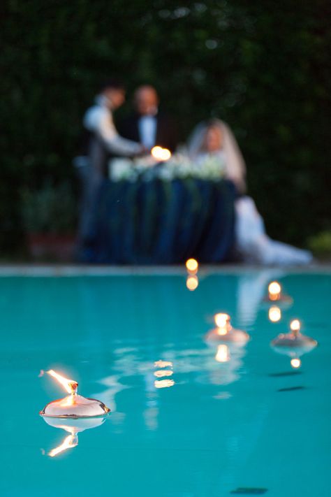 A gorgeous decoration for a poolside wedding reception is candles floating in the pool. #TheTuscanWedding Floating Lights In Pool, Lights In Pool, Poolside Wedding Ceremony, Poolside Wedding Reception, Floating Pool Candles, Backyard Wedding Pool, Poolside Wedding, Pool Candles, Pool Wedding