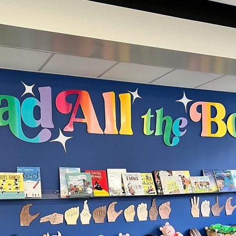 Mike on Instagram: "New addition! When I saw this in @teachergolz library, I knew I needed @ohsojo_ to make one for me too. Delivered over the holiday break, I got it up yesterday. The perfect final touch to this wall in the picture book section of our school library. 🌈✨💖📚#library #librariesofinstagram #librarian #librariansofinstagram #bookstagram #bookstagrammer #booklife #read #books #bookish #teachersfollowteachers #teachersofinstagram #iteachtoo" Elementary School Library Bulletin Boards, Library Wall Design, Library Bulletin Boards Elementary, Library Decorating Ideas, School Library Themes, Library Bulletin Board Ideas, Library Display Ideas, Library Doors, School Library Activities